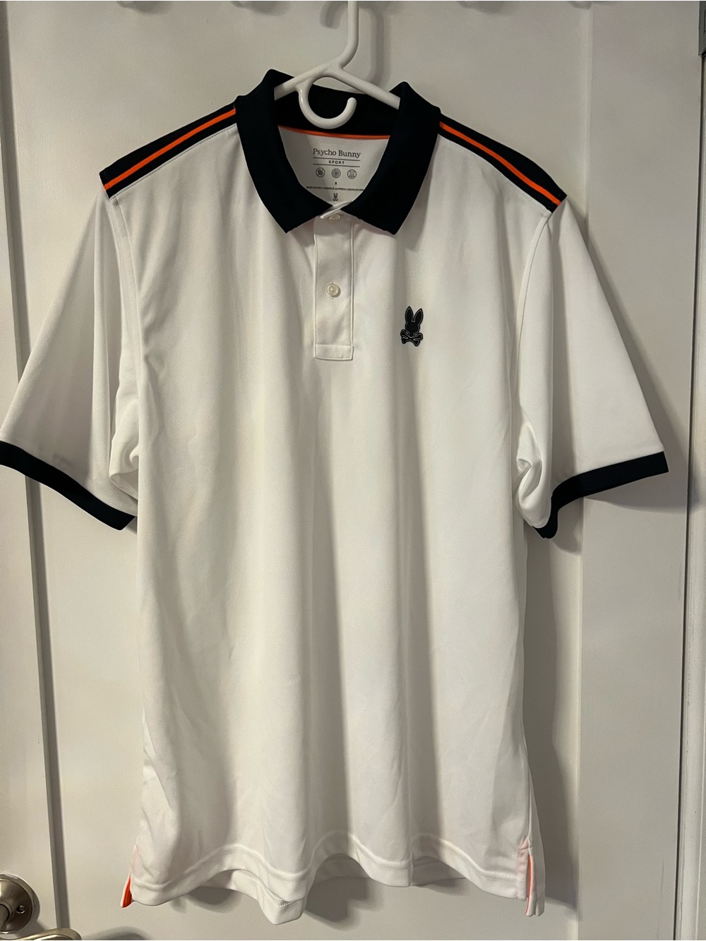 Psycho Bunny White Polo with Black Collar and Orange Shoulder Stripes
